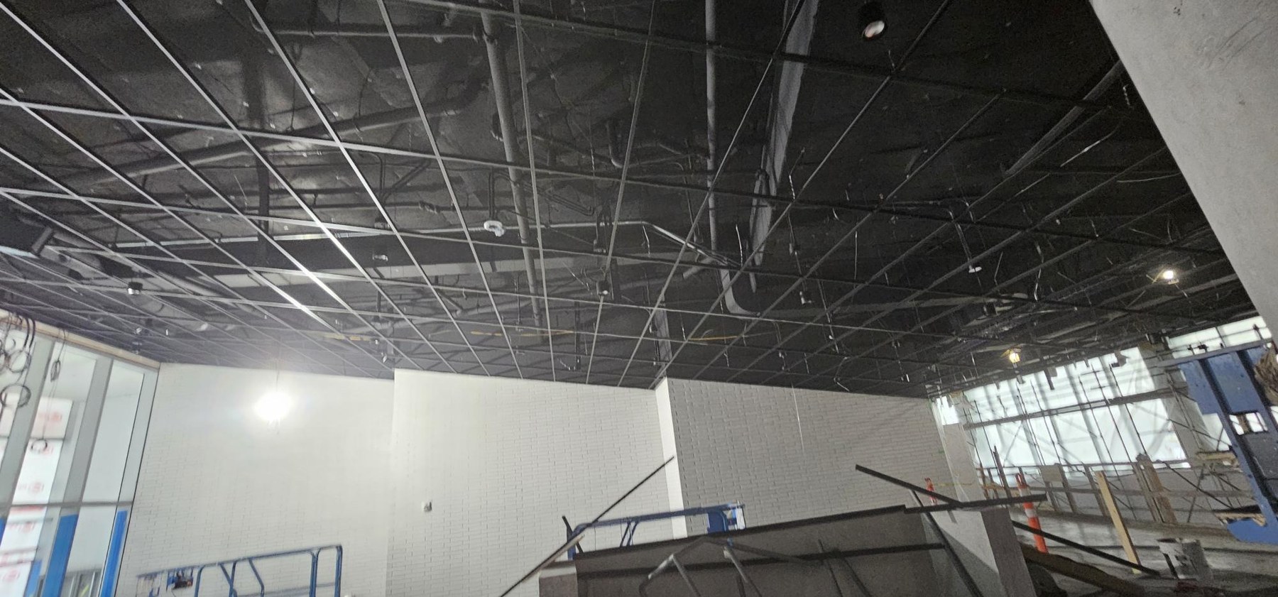 School of Biomedical Engineering, UBC Sloped black grid install for wood ceilings