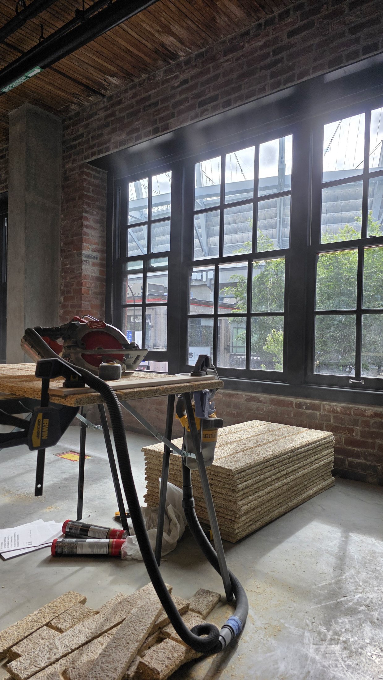 Tectum acoustic panels laid out before wall installation at 837 Beatty Street.