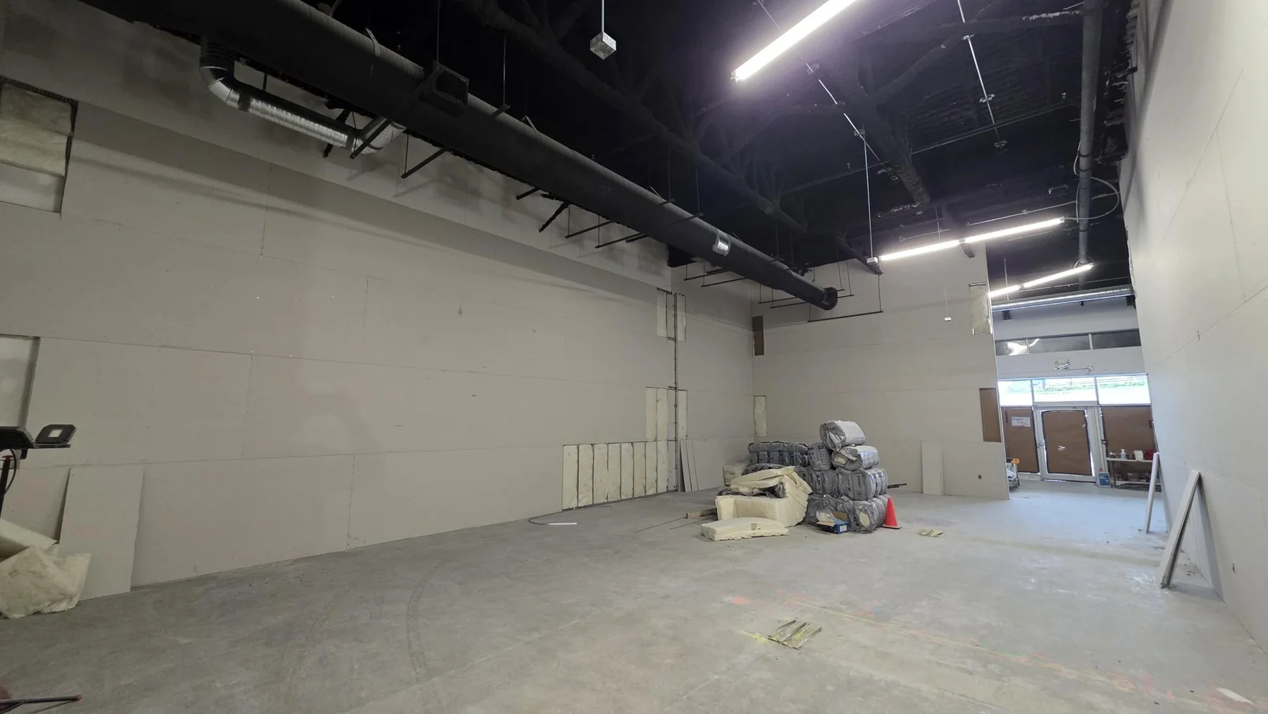 Boarded partitions during the Club Champion retail tenant improvement in Surrey.