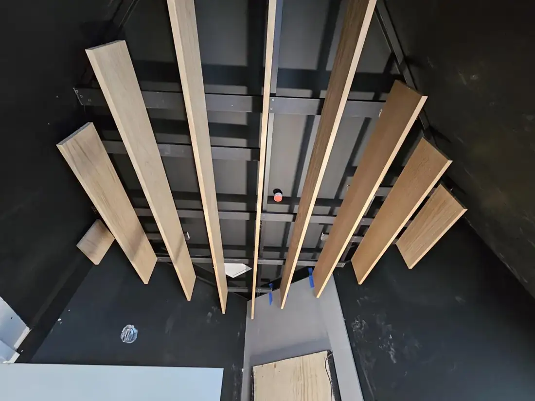 Wood baffles form a warm ceiling feature in the Thai restaurant.