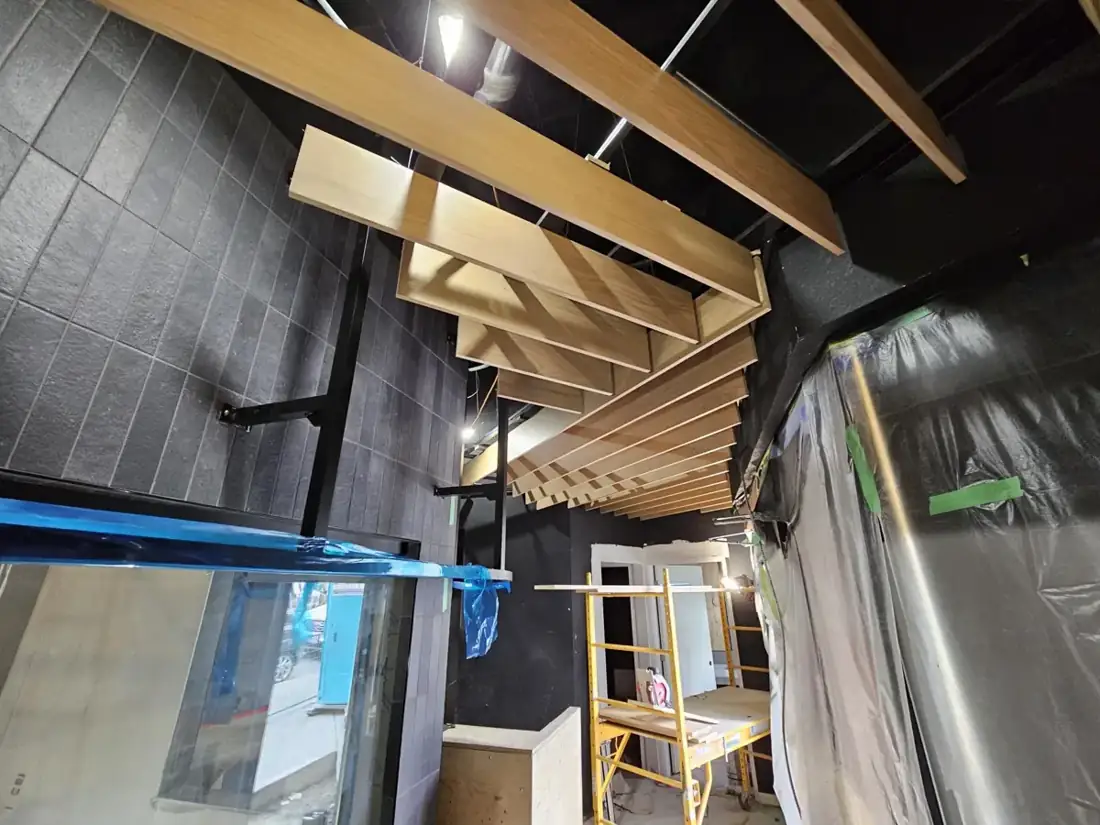 The baffle installation taking shape around overhead services.