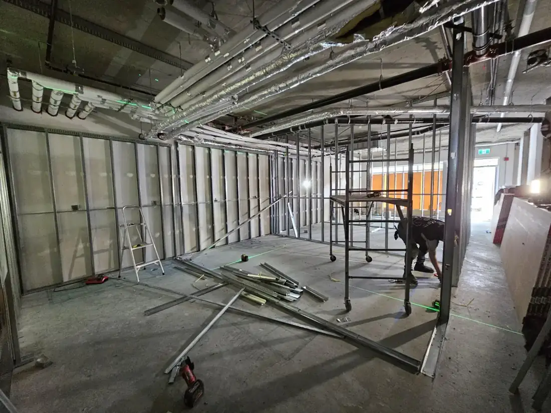 A wider view of the steel stud partition work in Langley.