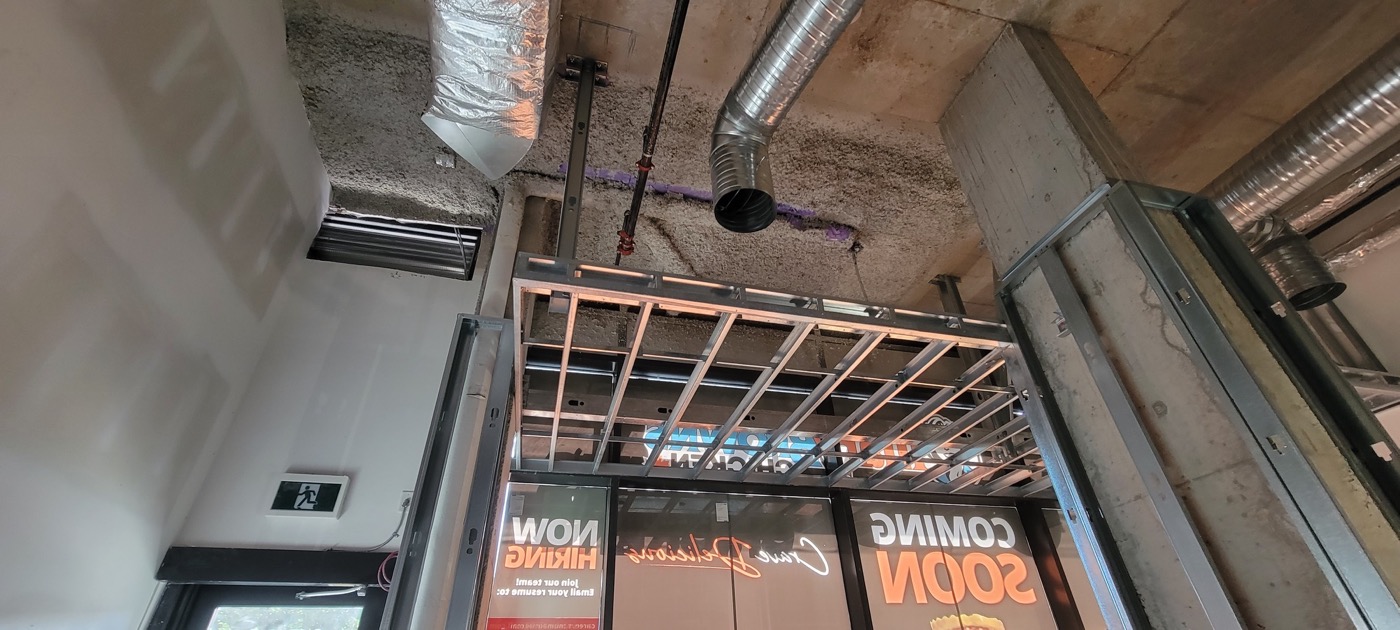 Commercial ceiling framing and curved bulkhead work in progress.