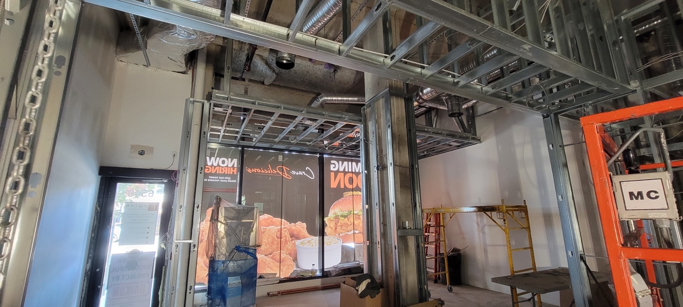 Commercial interior framing beneath exposed building services.