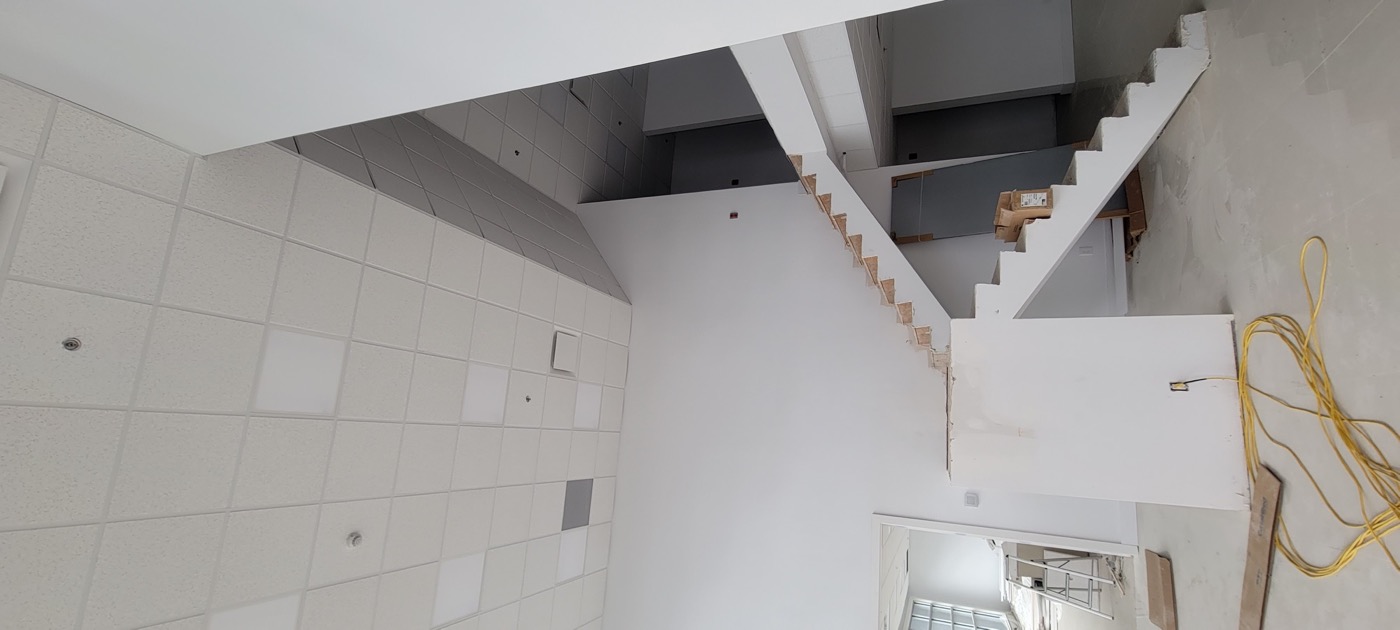 Completed suspended T-bar ceiling around an architectural column.