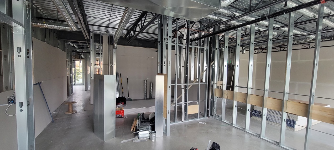 Steel stud partitions and interior framing in progress on a commercial floor.