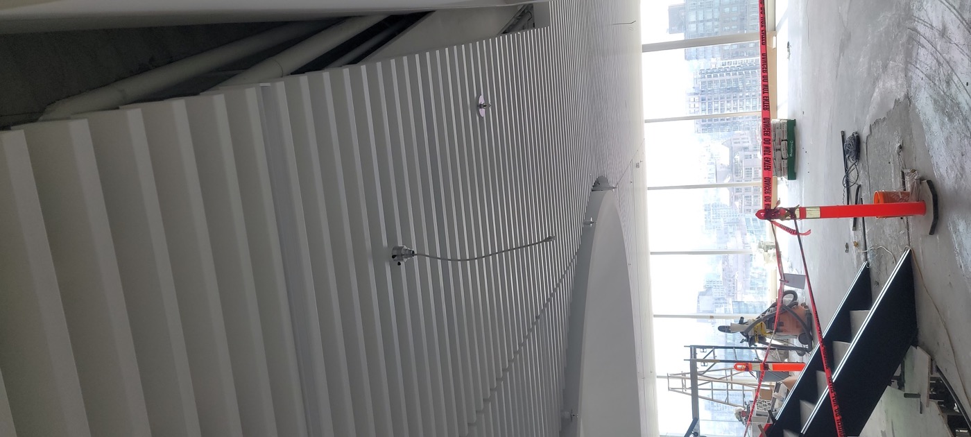 Linear ceiling slats and integrated lighting in a commercial project.