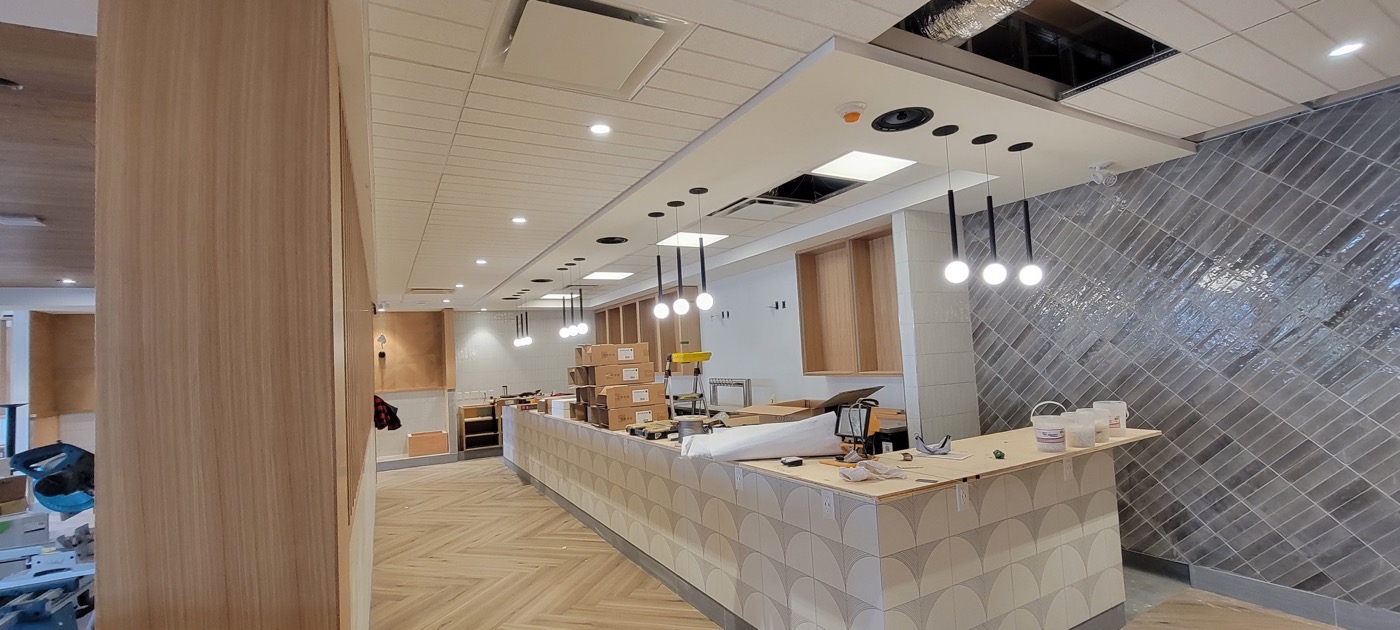 Wood-slat feature ceiling and integrated lighting in a finished interior.