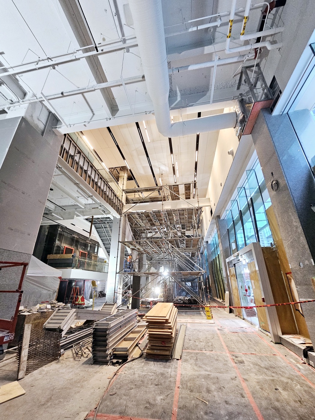 Commercial ceiling installation in progress beneath exposed structure.