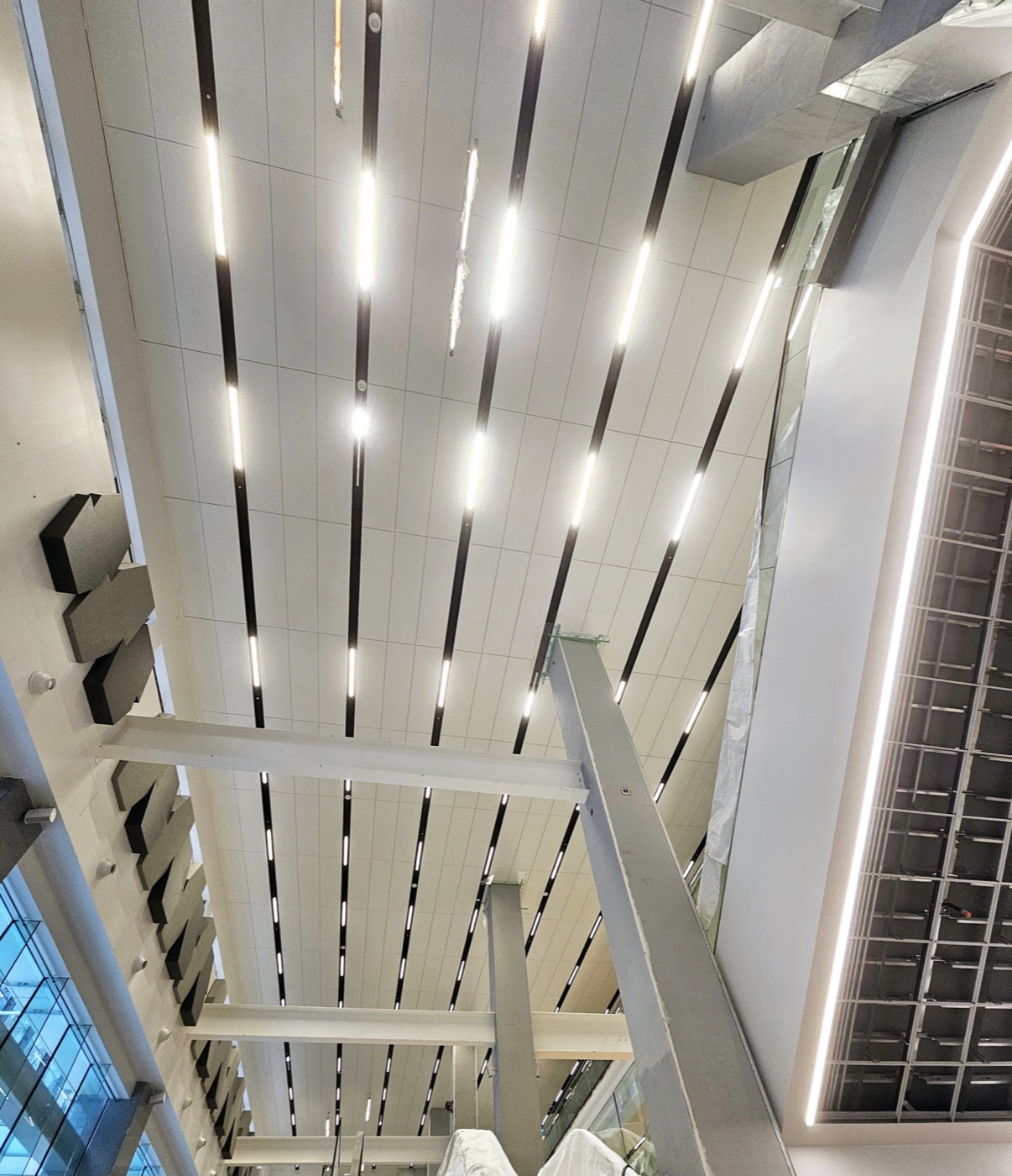 Completed linear-panel feature ceiling with recessed lighting.
