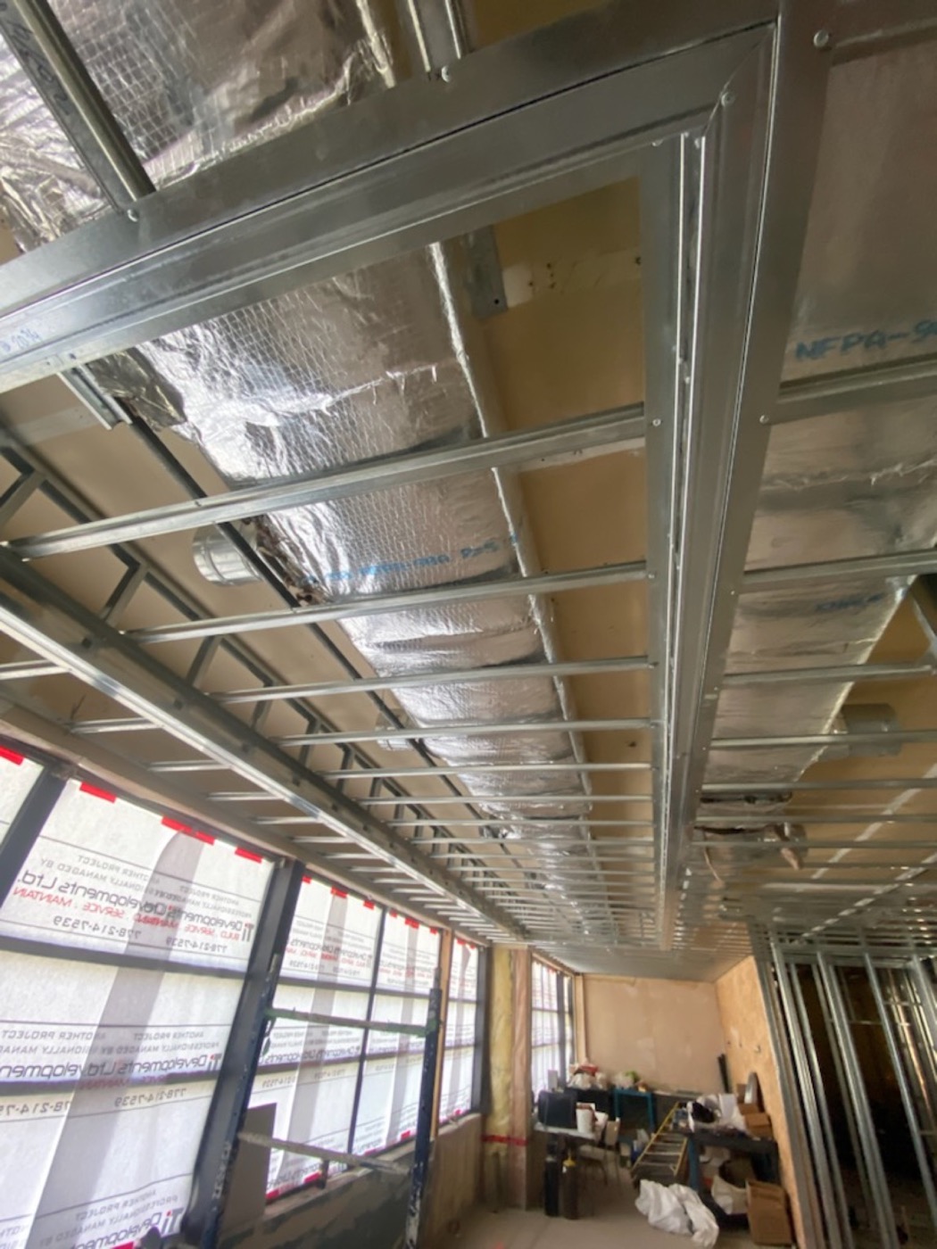 Commercial ceiling backing and steel stud wall framing in progress.