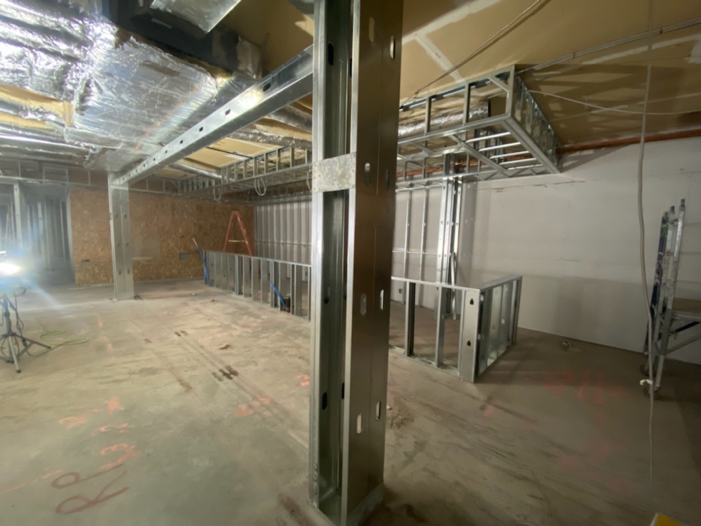 Steel stud partitions built around existing columns in a commercial renovation.