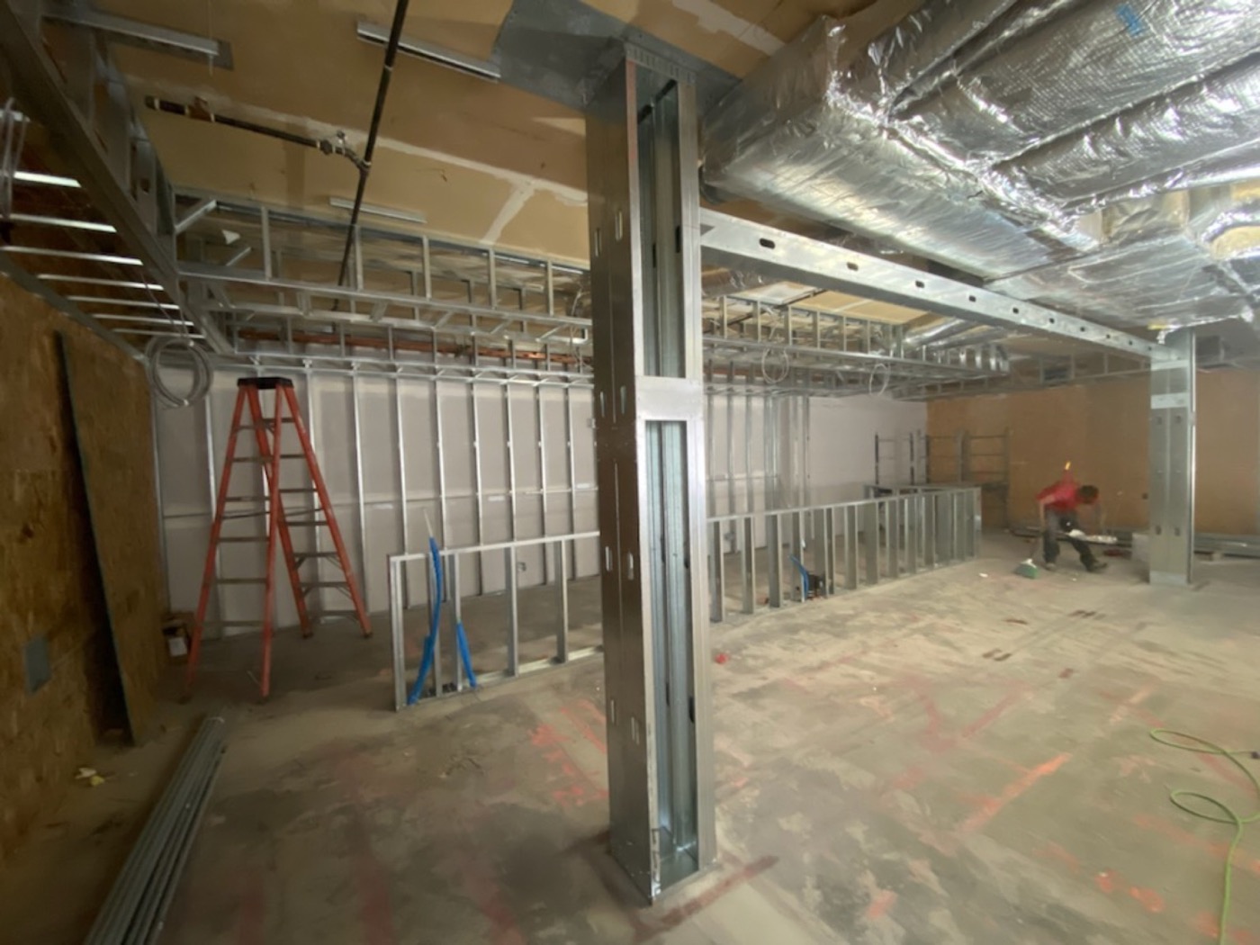 Wide view of steel stud partitions on a commercial construction floor.