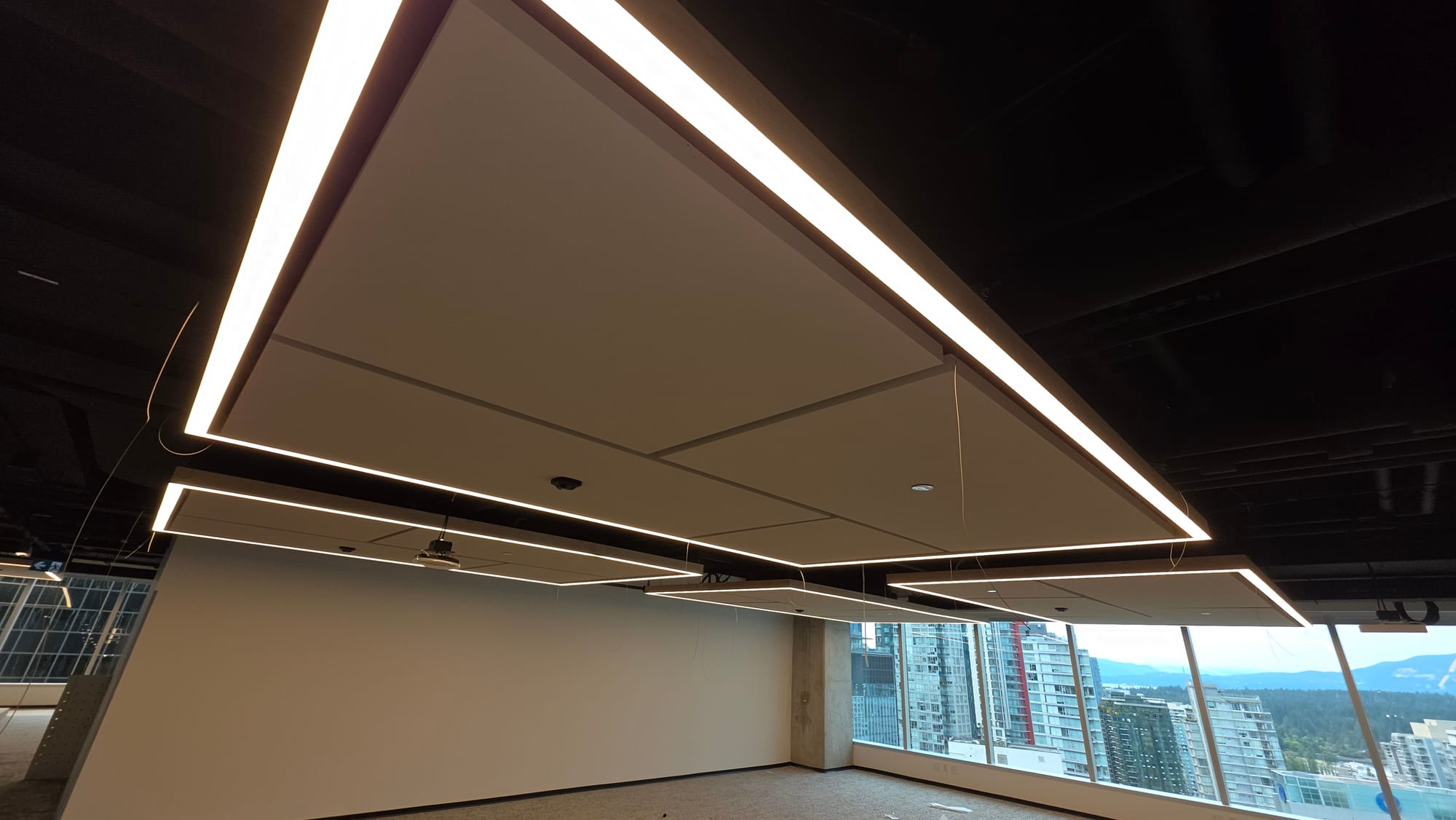 Close detail of suspended acoustic cloud panels installed for Microsoft.