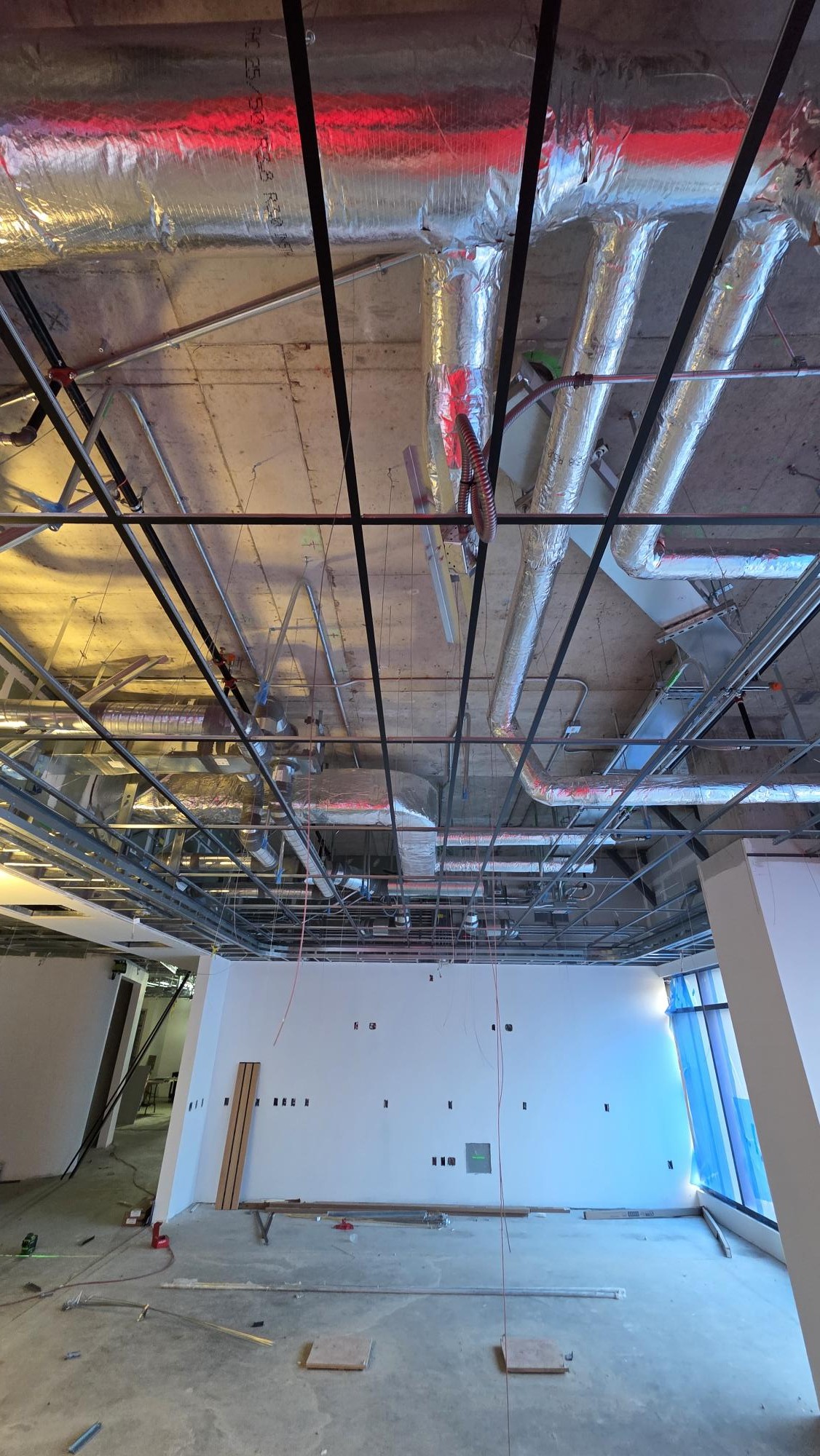 An upward view records the ceiling grid below exposed ductwork and other services.